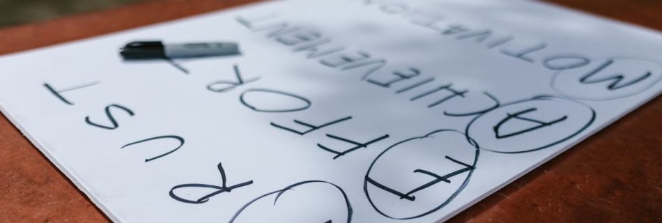 A paper with motivational words and markings placed outdoors on a table.